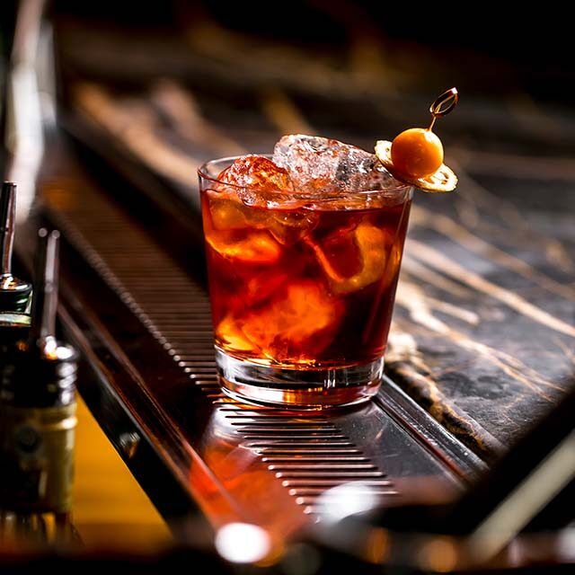 cocktail-glass-with-ice-cubes-garnished-with-dried-lemon-fruit