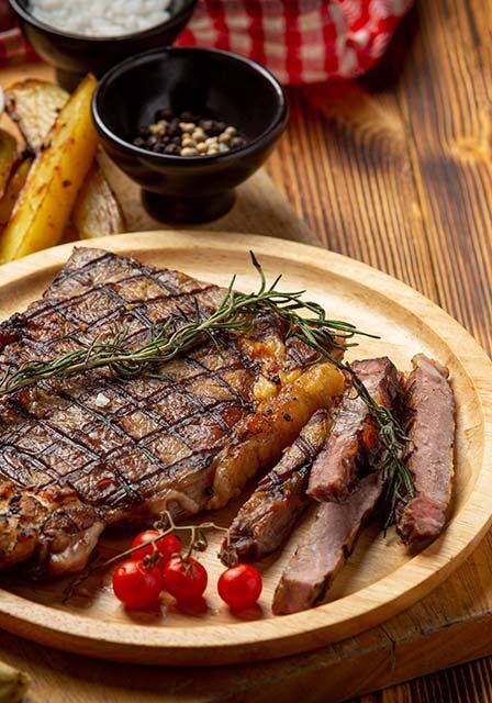 grilled-beef-steak-dark-wooden-surface